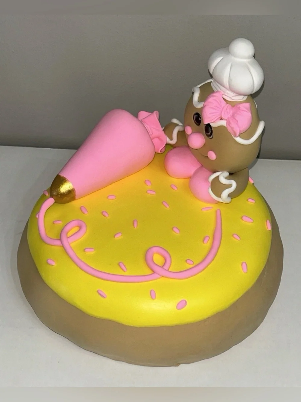 Whimsical Pink & Yellow Fake Gingerbread Baker on Giant Sugar Cookie Display